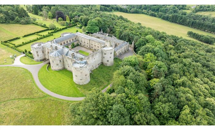 An aerial view of a Chirk Castle surrounded by lush greenery and open fields. National Trust Images/Paul Harris